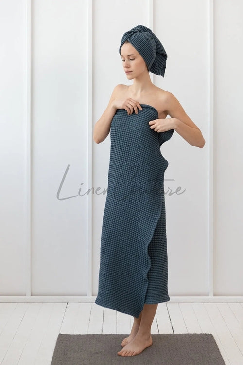 Woman wrapped in navy blue waffle weave cotton towel with matching hair wrap — lightweight, breathable spa towel ideal for post-shower comfort and travel use