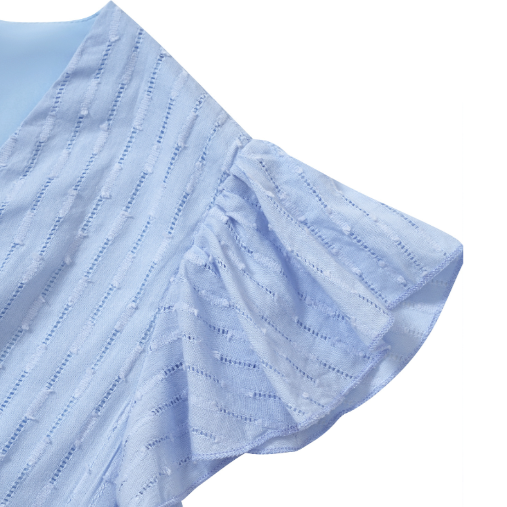 Close-up of the light blue ruffle sleeve on a textured midi dress, showcasing soft fabric, delicate stitching, and subtle vertical dotted pattern for a feminine and airy look.