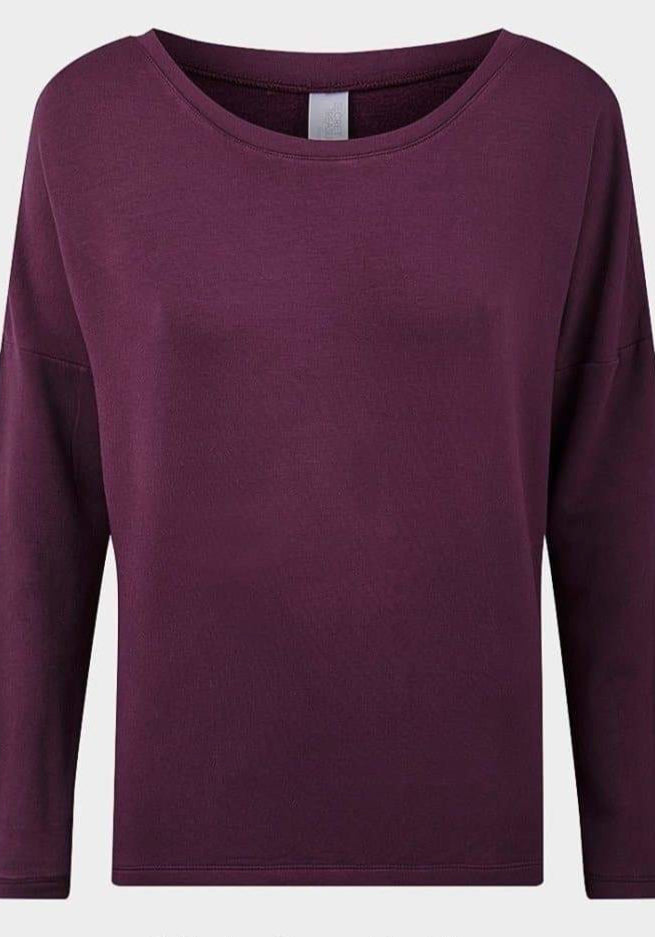 Front view of a women’s plum-colored long sleeve top with a wide round neckline and relaxed fit, marked as “Sold Out.” A versatile wardrobe staple by De La Creme Fashions.